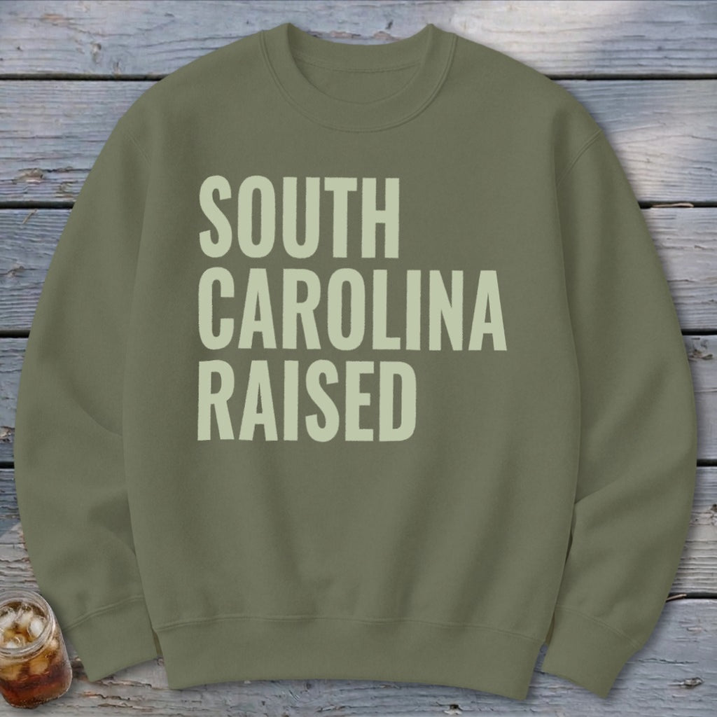 Olive green sweatshirt with "SOUTH CAROLINA RAISED" text.