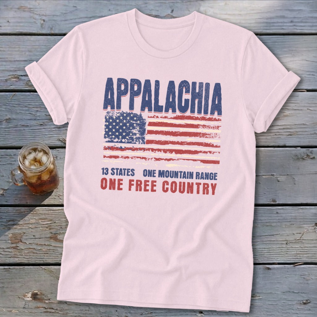 A light pink t-shirt featuring a distressed American flag graphic, the word Appalachia, and patriotic text.