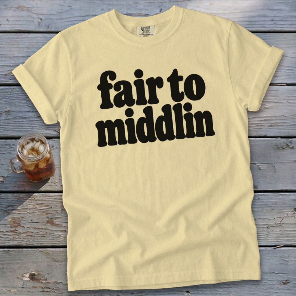 Light yellow t-shirt with black text "fair to middlin" and a glass of iced tea.