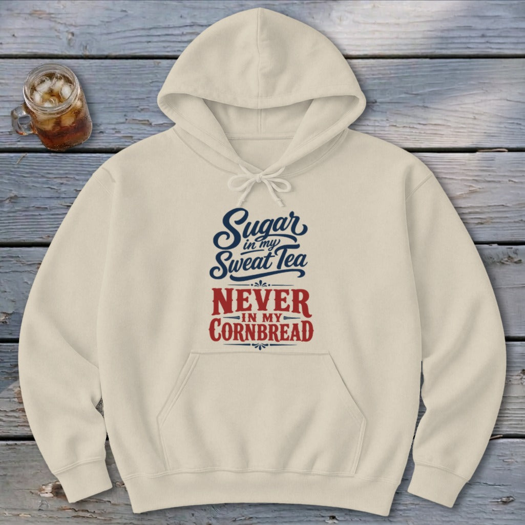 Cream-colored hoodie featuring blue and red text that reads, Sugar in my sweet tea never in my cornbread.