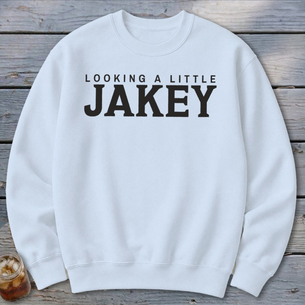 White sweatshirt with "LOOKING A LITTLE JAKEY" text.