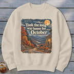 Sweatshirt with autumn scenic road and "Took the long way home for October" text.