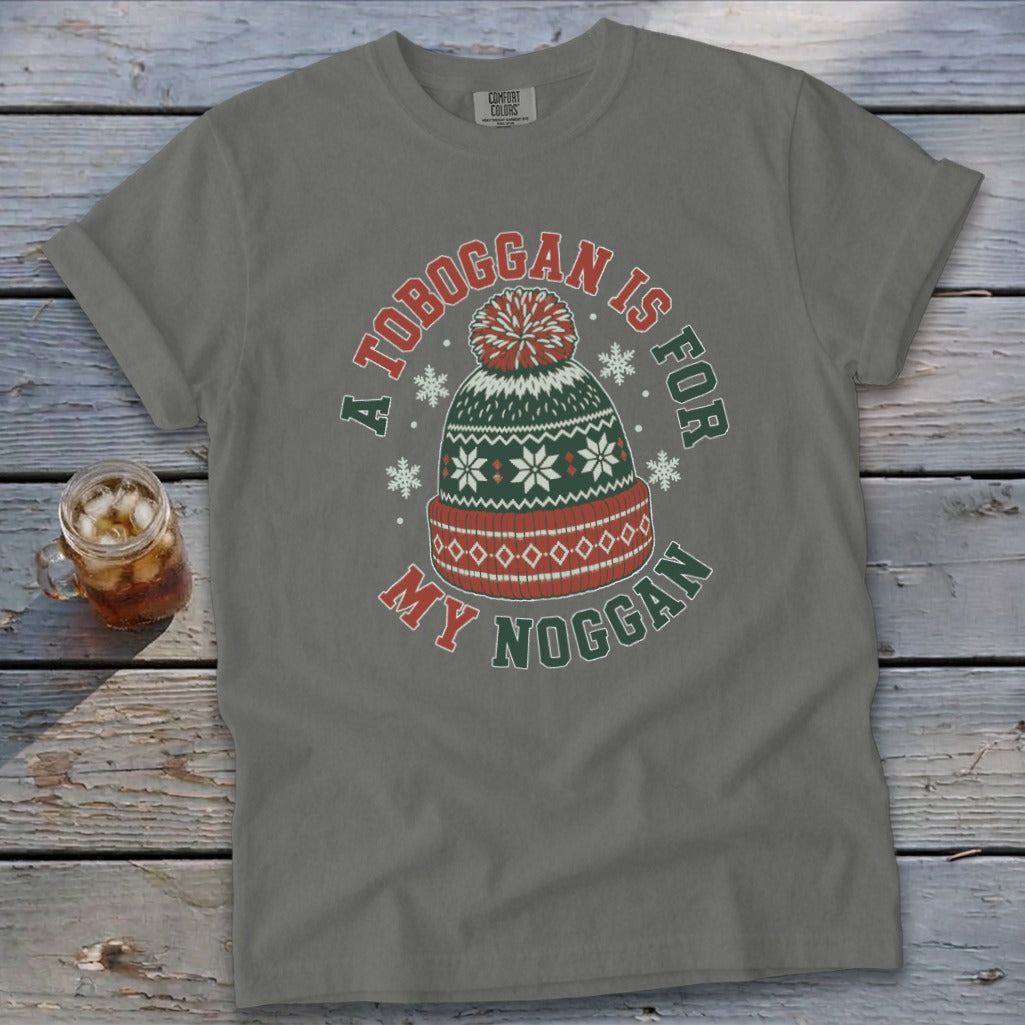 Gray t-shirt with festive winter hat graphic and text reading "A Toboggan is for my Noggan".