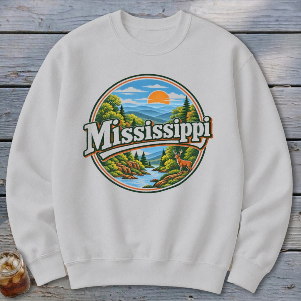 White sweatshirt with circular graphic featuring "Mississippi" text, mountains, river, trees, and a deer.