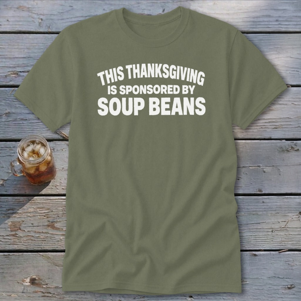 An olive green t-shirt with white text that reads This Thanksgiving Is Sponsored By Soup Beans.