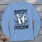 Light blue long-sleeve shirt with text and graphic of bare feet on a rock in water.