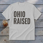 White t-shirt with "OHIO RAISED" printed in dark gray text.