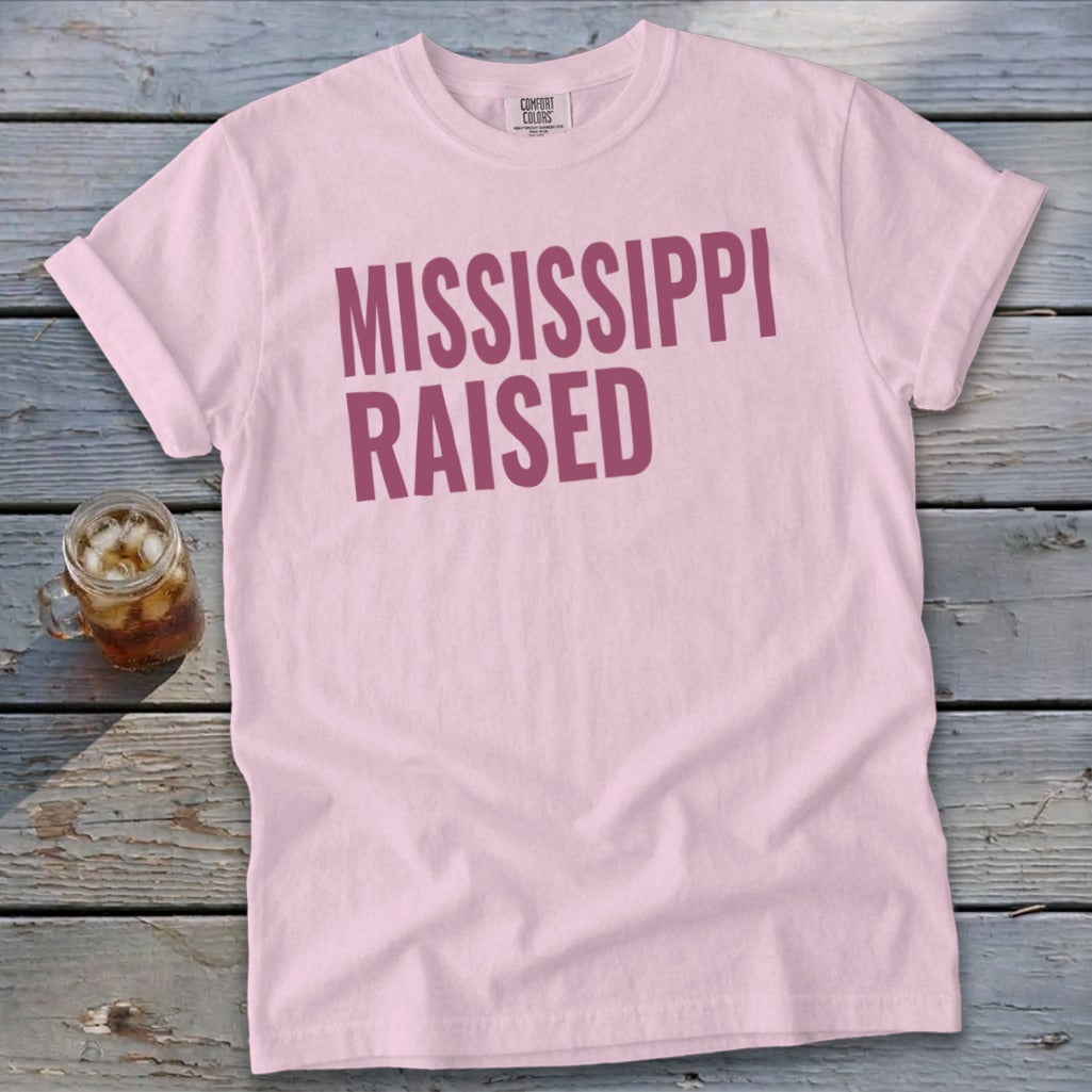 Pink t-shirt with "MISSISSIPPI RAISED" in maroon text.