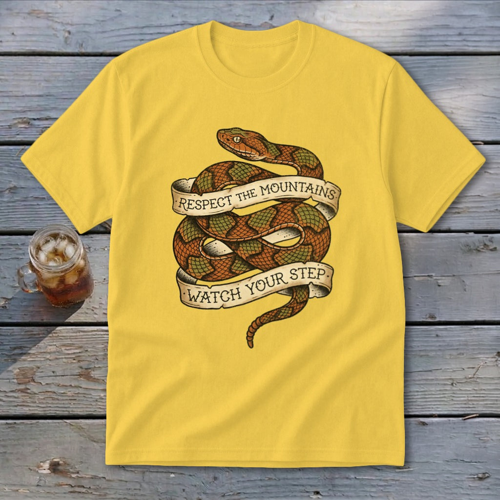 Yellow t-shirt with coiled snake and banner reading "Respect the Mountains Watch Your Step".