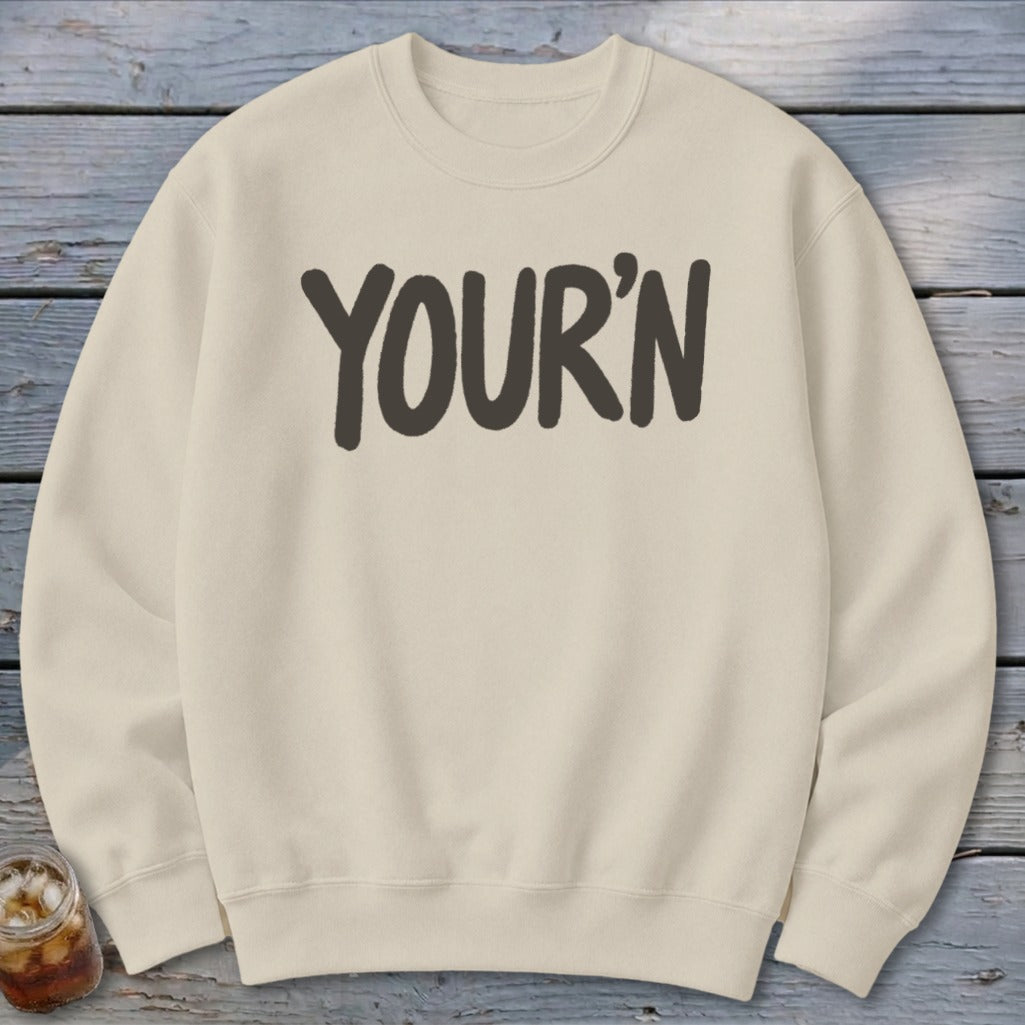 Cream sweatshirt with "YOUR'N" printed in dark gray on the chest.