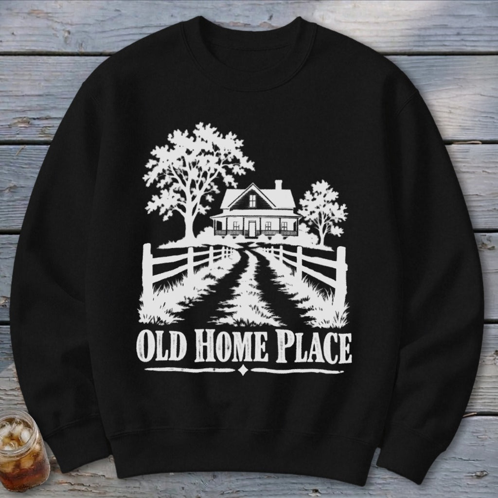 Black sweatshirt with white graphic of a farmhouse, trees, and the text "OLD HOME PLACE".