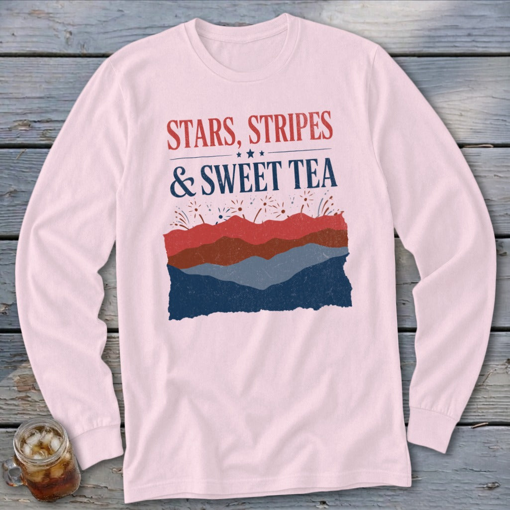 Light pink long-sleeve t-shirt with red, white, and blue graphic text reading Stars, Stripes & Sweet Tea.