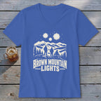 Blue V-neck t-shirt featuring a graphic of three hikers looking at glowing mountain lights.