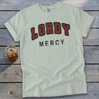 Light blue t-shirt with "LORDY MERCY" printed in red and black lettering.