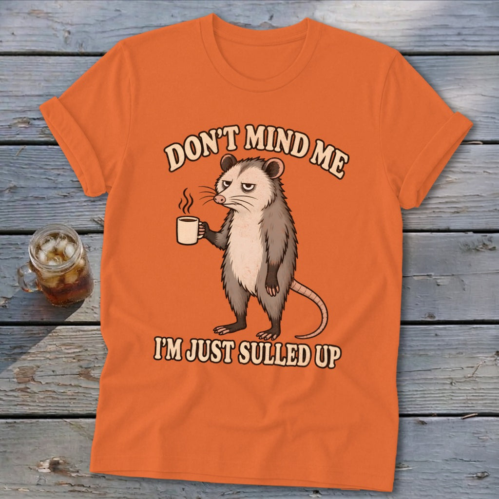 Orange t-shirt with possum graphic and text "DON'T MIND ME I'M JUST SULLED UP".