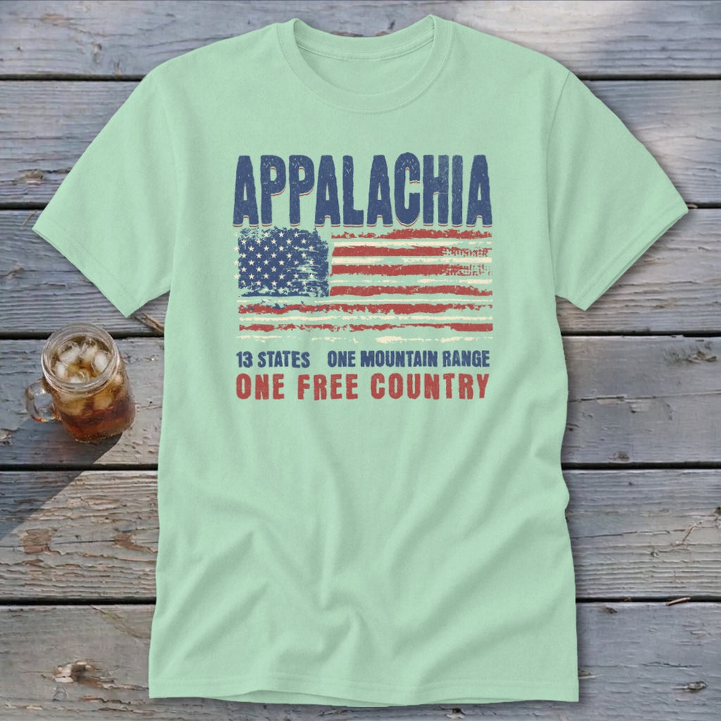 A light green short-sleeve t-shirt with a distressed graphic featuring the American flag and the text Appalachia, 13 States, One Mountain Range, One Free Country.