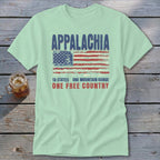A light green short-sleeve t-shirt with a distressed graphic featuring the American flag and the text Appalachia, 13 States, One Mountain Range, One Free Country.