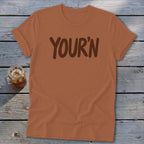 Brown t-shirt with "YOUR'N" printed in dark brown text.