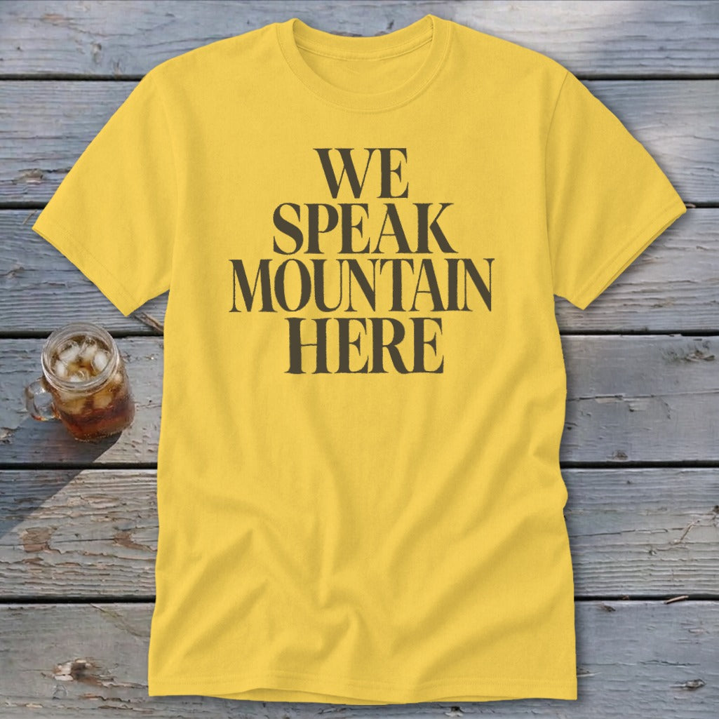 Yellow t-shirt with black text that reads "WE SPEAK MOUNTAIN HERE."