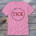 Pink t-shirt with "FULL AS A TICK" text inside a circle.