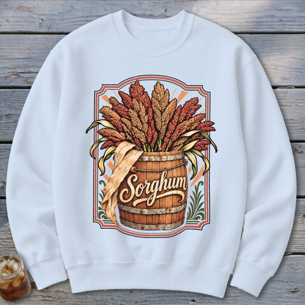 White sweatshirt with a vintage "Sorghum" graphic featuring a wooden barrel overflowing with sorghum stalks.