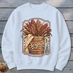 White sweatshirt with a vintage "Sorghum" graphic featuring a wooden barrel overflowing with sorghum stalks.
