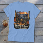 Light blue t-shirt with rocking chairs on a porch and "Pull up a chair The holler's talkin'" text.