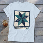 Light blue t-shirt with a quilt block design featuring an eight-pointed star and text.