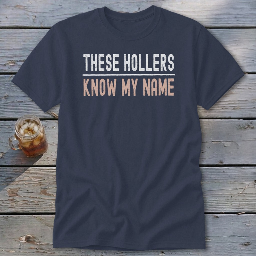 Navy t-shirt with white and peach text that reads "THESE HOLLERS KNOW MY NAME".