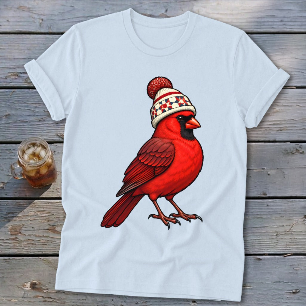 A light blue t-shirt printed with a vibrant red cardinal wearing a winter beanie.