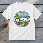 White t-shirt with circular Georgia landscape graphic featuring mountains, river, deer, and sun.