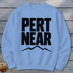 Light blue crewneck sweatshirt featuring black text reading PERT NEAR above a mountain outline.