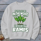 Light gray crewneck sweatshirt featuring green text reading "IF YOU SEE ME IN THE WOODS I'M HUNTIN' RAMPS" and an illustration of three ramps.