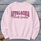 Pink sweatshirt with "APPALACHIA #North Carolina" text in burgundy.