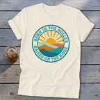 Cream t-shirt with a round graphic of mountains and a sun, plus text reading Born in the Holler Raised on the Ridge.