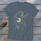 Bear playing a banjo while sitting on a stool, illustration on a t-shirt.