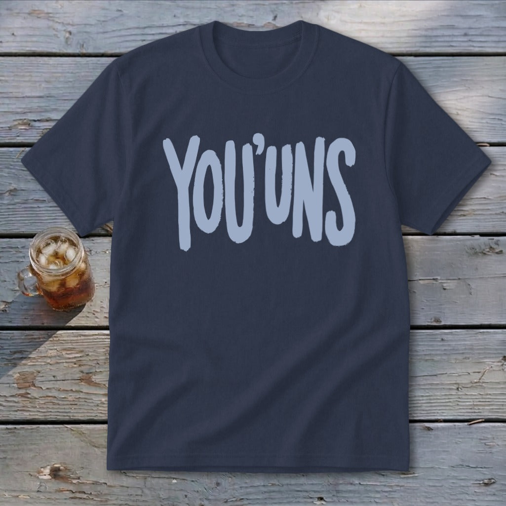 Navy t-shirt with light blue "YOU' UNS" text, next to a glass of iced tea.
