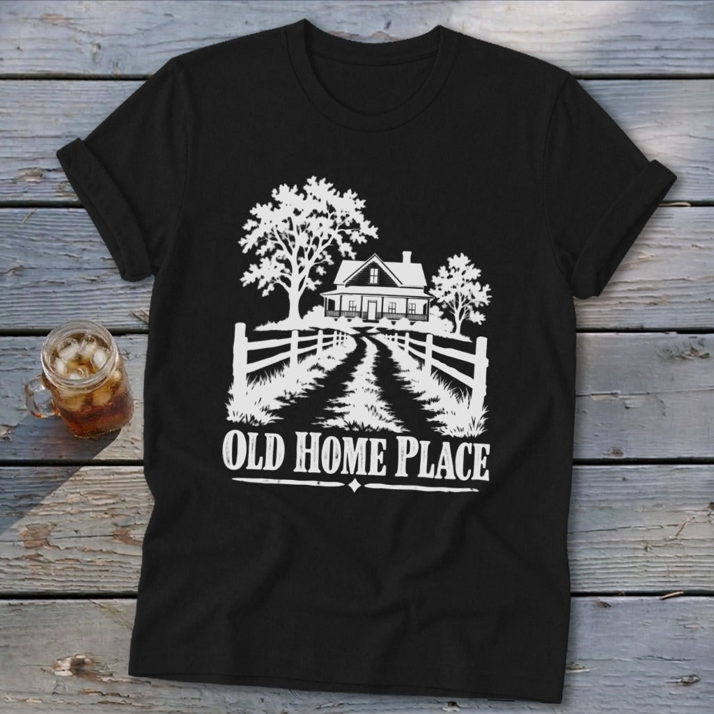 Black t-shirt with white graphic of farmhouse, trees, and text "OLD HOME PLACE".