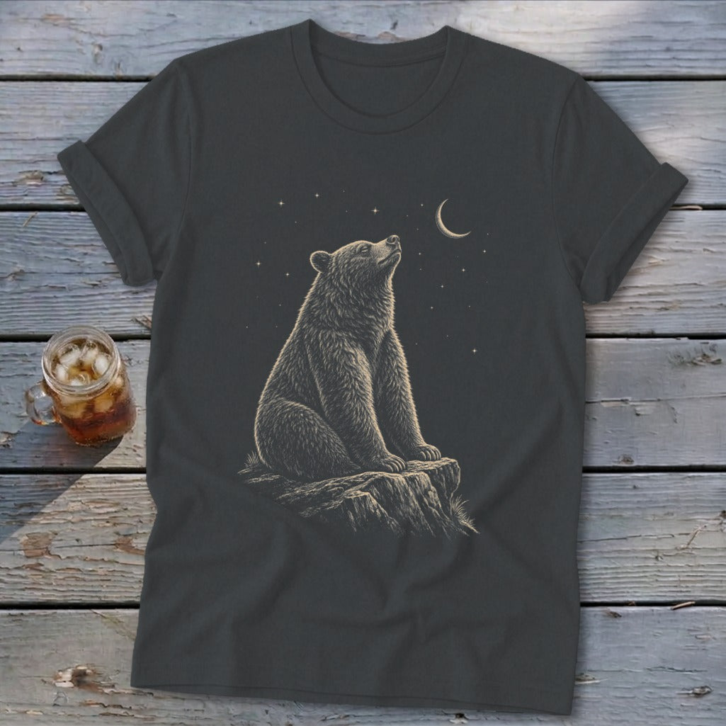 Dark t-shirt with illustration of a bear sitting on a rock looking up at the moon and stars.