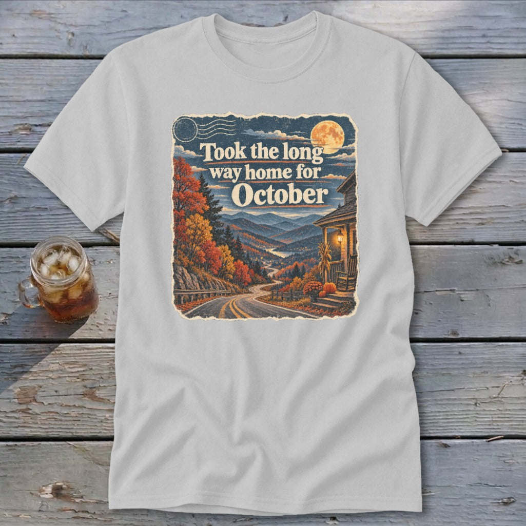 T-shirt graphic with autumn mountain road, house, and text "Took the long way home for October".