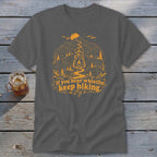 Dark grey t-shirt with orange mountain and lantern graphic, "If you hear whistlin', keep hiking."