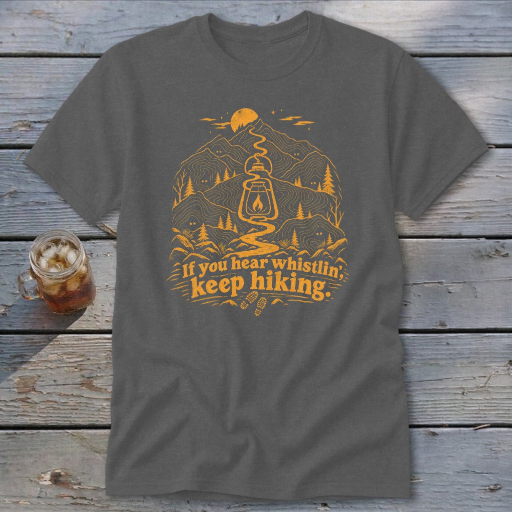 Dark grey t-shirt with orange mountain and lantern graphic, "If you hear whistlin', keep hiking."