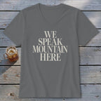 Grey V-neck t-shirt with "WE SPEAK MOUNTAIN HERE" text and glass of iced tea.