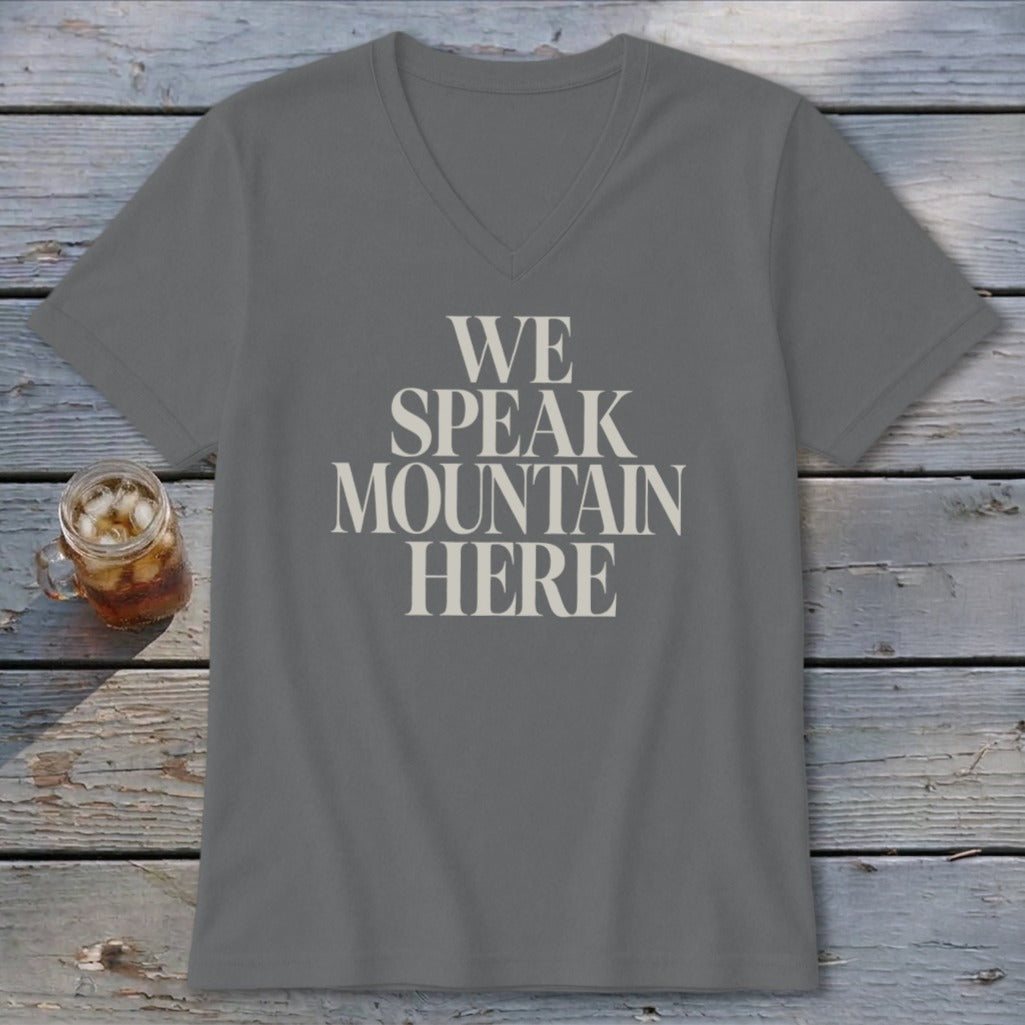 Grey V-neck t-shirt with "WE SPEAK MOUNTAIN HERE" text and glass of iced tea.