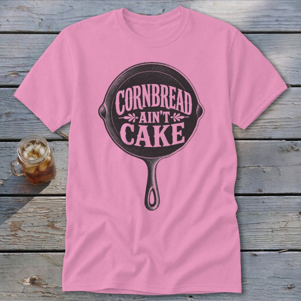 Pink t-shirt with cast iron skillet graphic and text "Cornbread ain't cake."