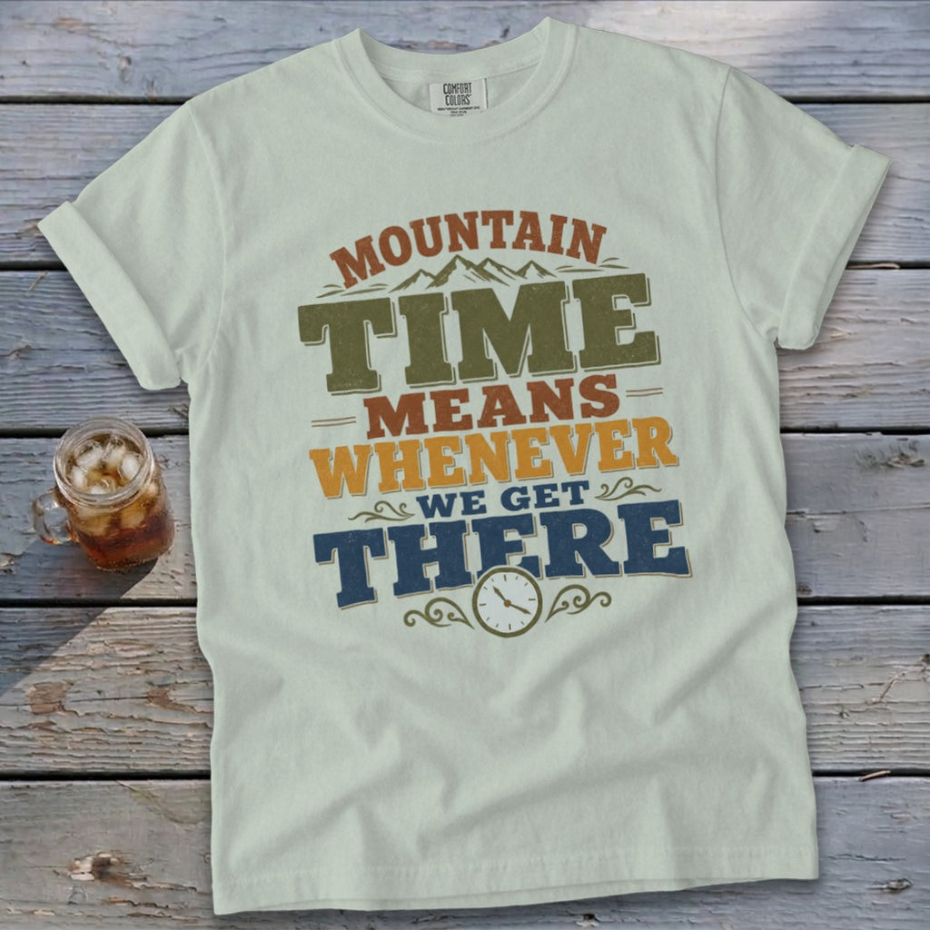 White t-shirt with "Mountain Time Means Whenever We Get There" graphic and clock detail.