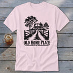 Light pink t-shirt with black graphic of a farmhouse, trees, and "OLD HOME PLACE" text.