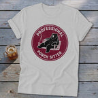 A light gray t-shirt featuring a circular maroon graphic of a bear lounging in a porch swing, surrounded by the text Professional Porch Sitter.