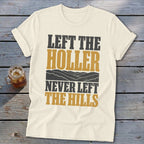 Cream t-shirt with text "LEFT THE HOLLER NEVER LEFT THE HILLS" and mountain graphic.