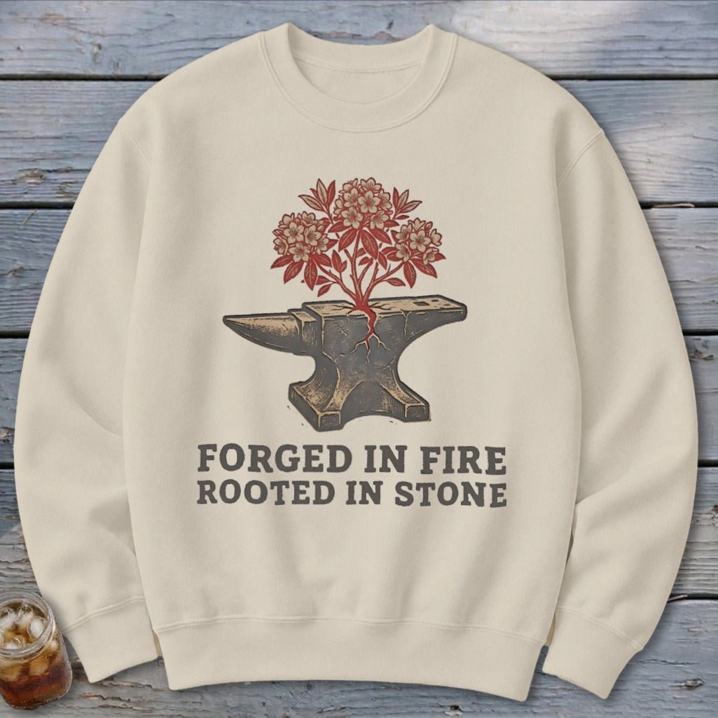 Cream sweatshirt with anvil graphic and text "FORGED IN FIRE ROOTED IN STONE".